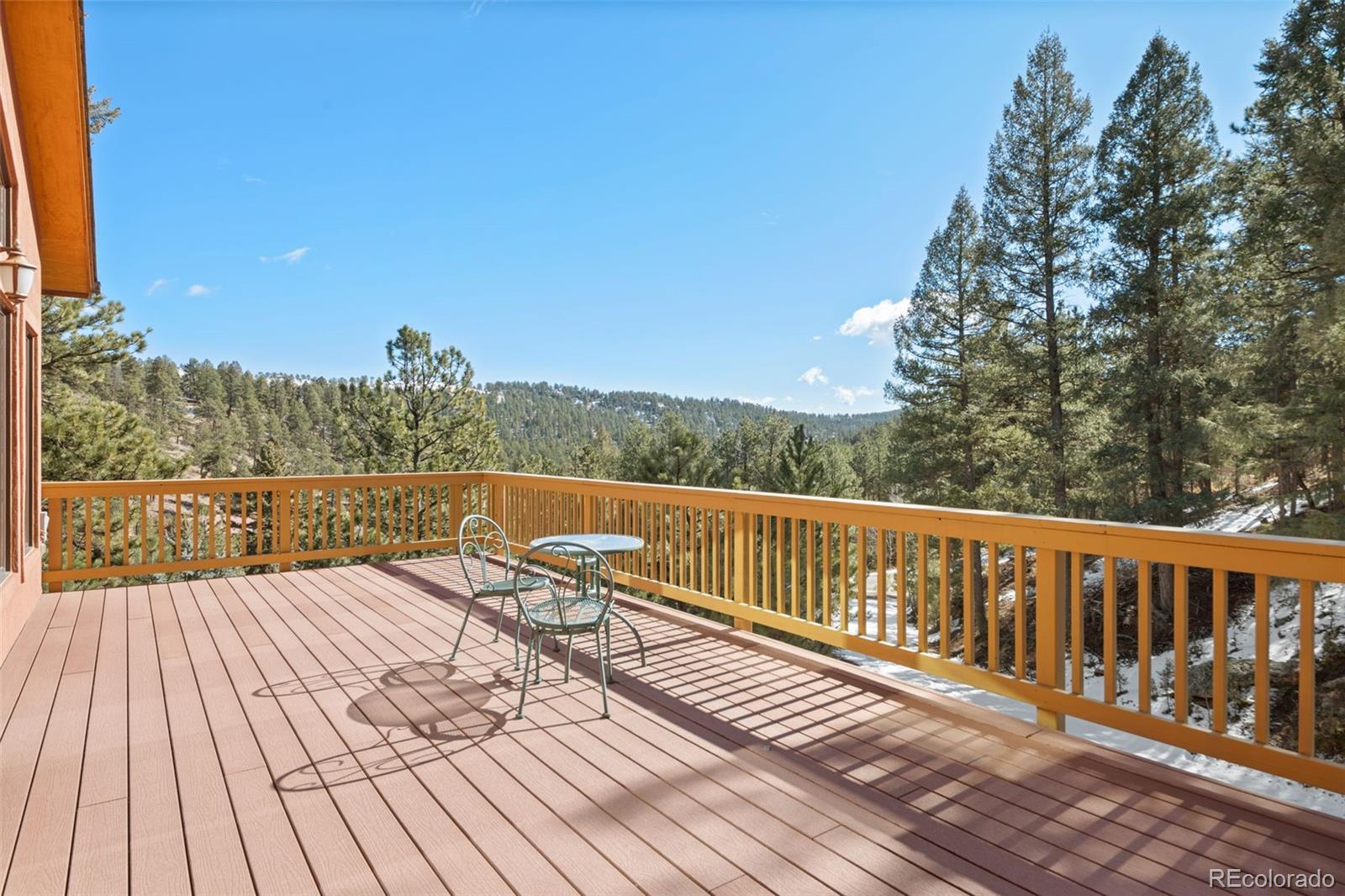1269 Roland Drive Bailey, CO 80421 - Photo 3 of 38 a view of balcony with wooden floor and fence