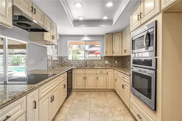 a kitchen with stainless steel appliances granite countertop a sink and dishwasher a stove with wooden floor