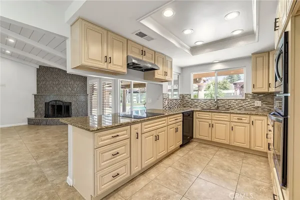 a kitchen with stainless steel appliances granite countertop a stove sink and cabinets