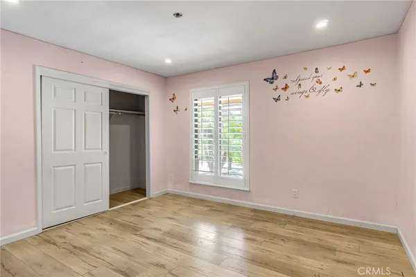 en empty room with window and a ceiling fan