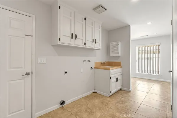 a view of a kitchen with closet and electronic appliances