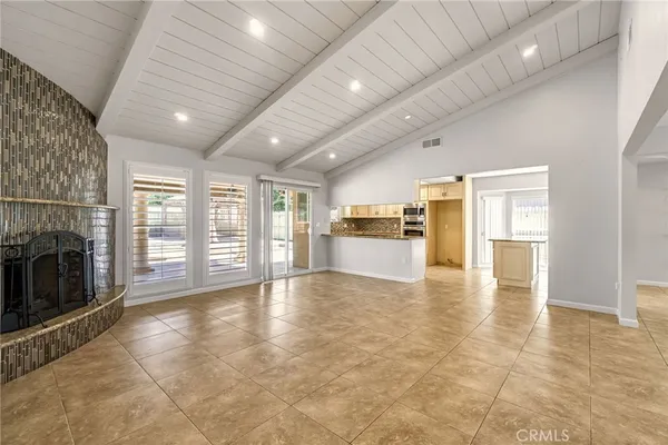 a view of empty room with wooden floor and fireplace