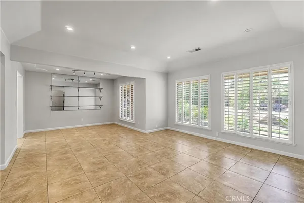 a view of an empty room with a window and a bathroom