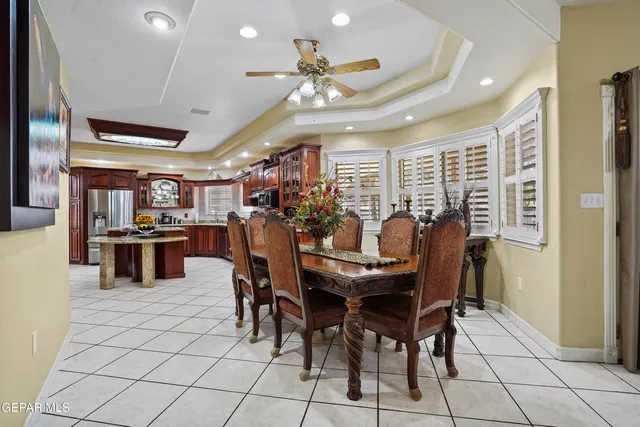 a view of a dining room with furniture and chandelier