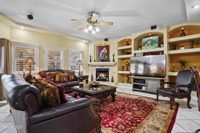 a living room with furniture a fireplace and a flat screen tv
