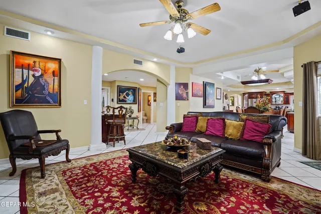 a living room with furniture a piano and a painting