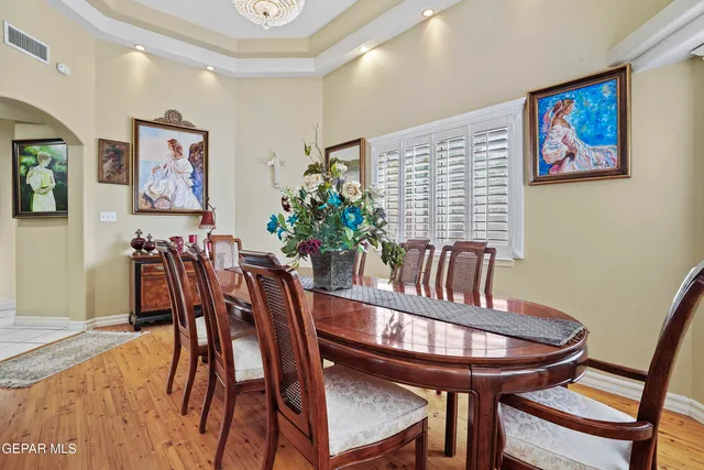 a view of a hallway with wooden floor and windows