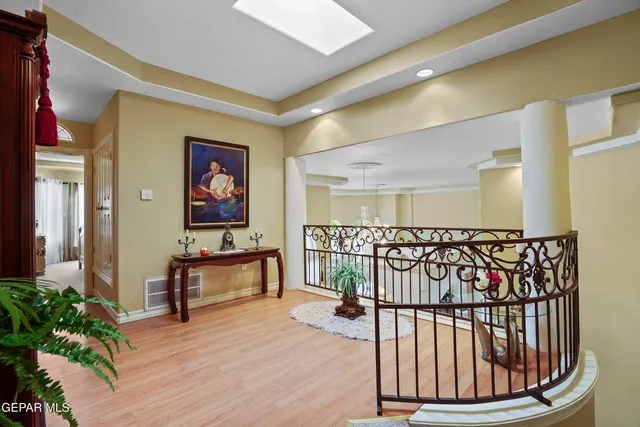 a living room with furniture a fireplace and a chandelier