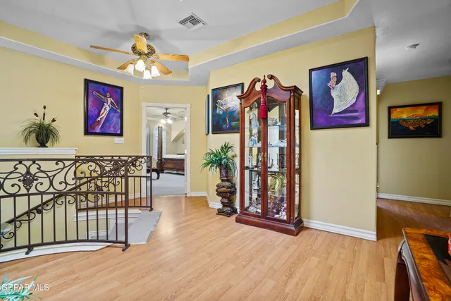 a spacious bedroom with a bed a couch and dresser