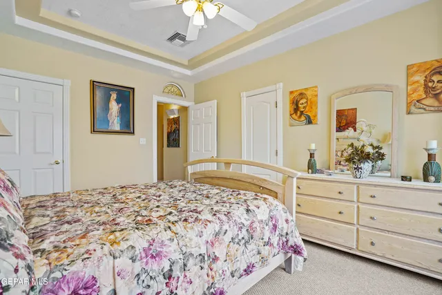 a spacious bedroom with a bed and a couch