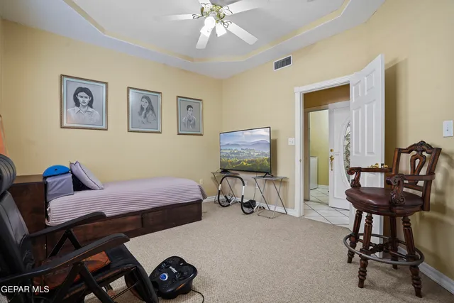 a front view of a house with a small yard and a large tree