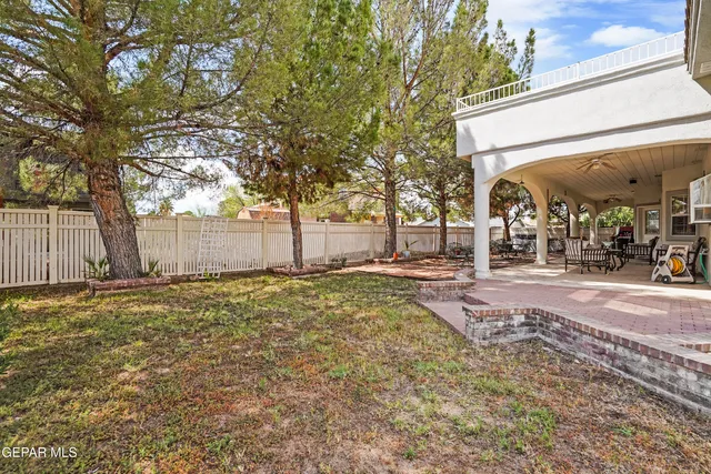 an aerial view of a house with a yard and potted plants