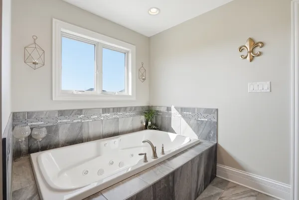 a bathroom with a tub and a window