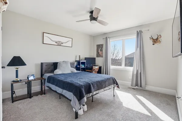 a bedroom with a bed and a chandelier