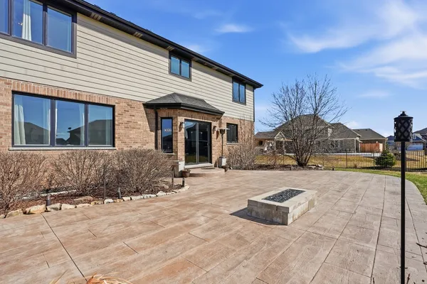 a swimming pool with outdoor seating and yard