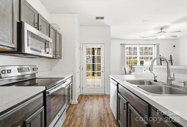 a kitchen that has a sink and a stove in it