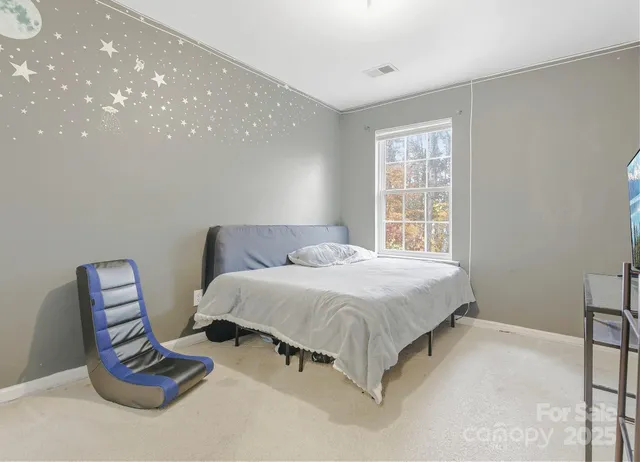 a spacious bedroom with a bed and a window