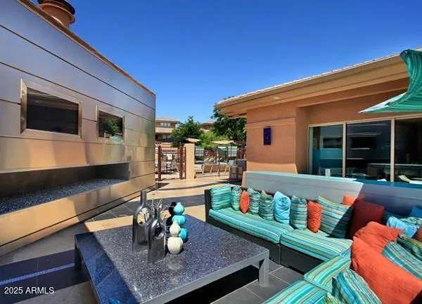 a outdoor living space with furniture and flat screen tv