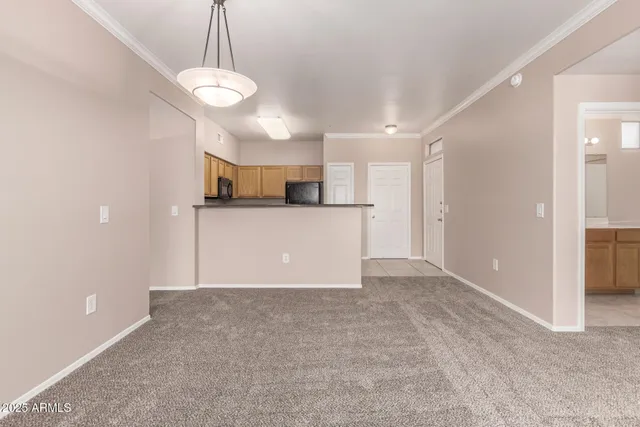 a view of a kitchen with a sink and a refrigerator
