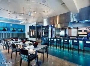 a dining hall with lots of wooden furniture a dining table and chairs