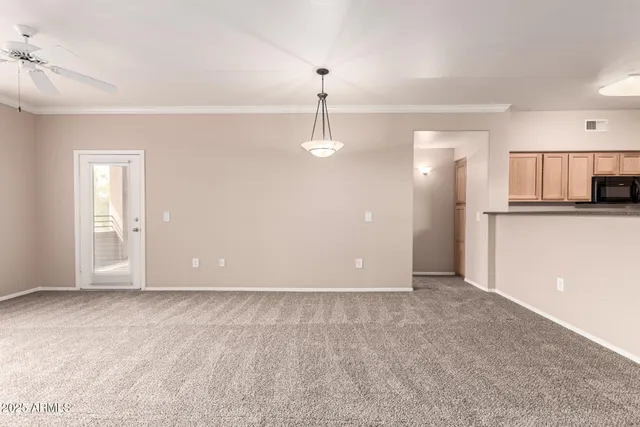 a view of a kitchen with a sink and a refrigerator