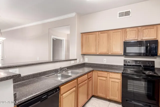 a kitchen with stainless steel appliances granite countertop a sink stove and microwave