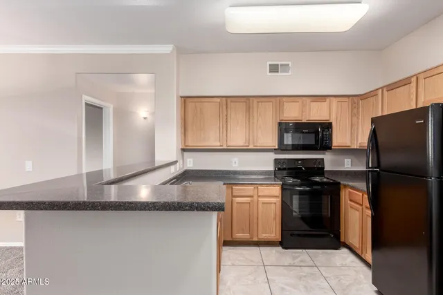 a kitchen with a refrigerator a sink and a stove