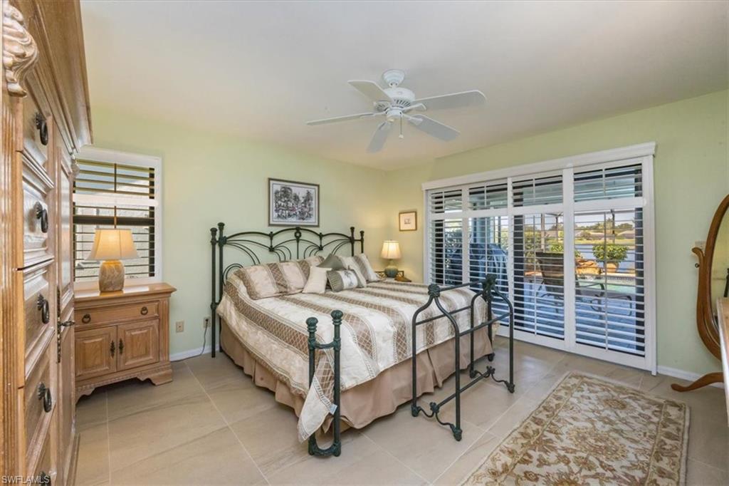 9534 Campbell Circle Naples, FL 34109 - Photo 15 of 31 a bed room with a bed and a window