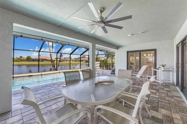 a dining room with furniture a floor to ceiling window and wooden floor