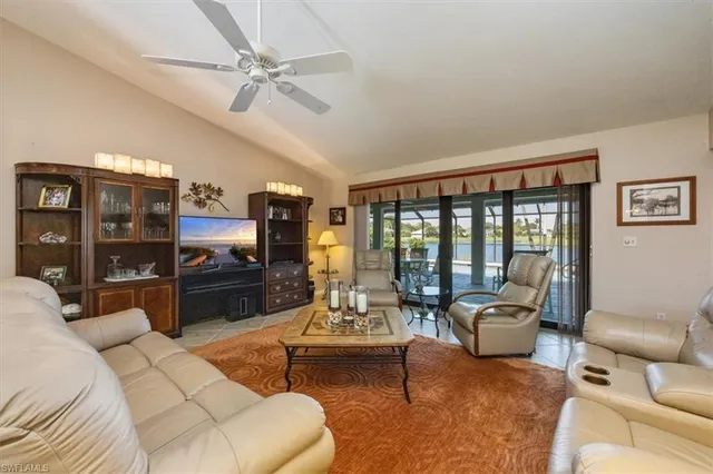a living room with furniture and large windows