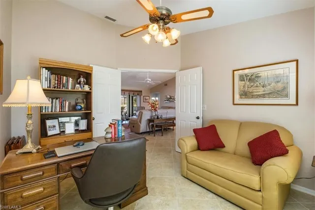a living room with furniture and a bookshelf