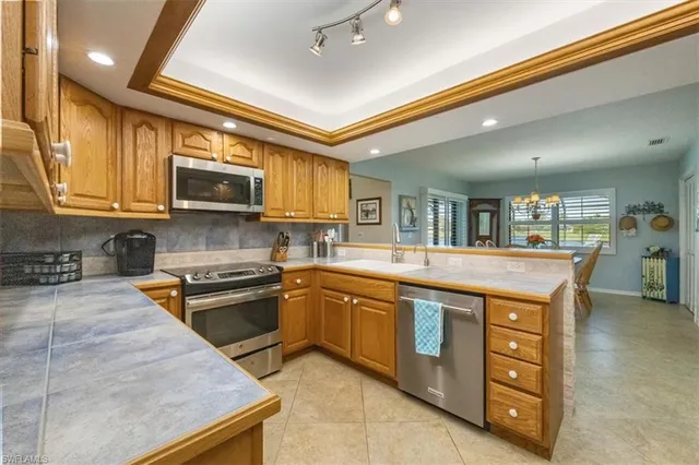a kitchen with stainless steel appliances granite countertop a stove and a sink