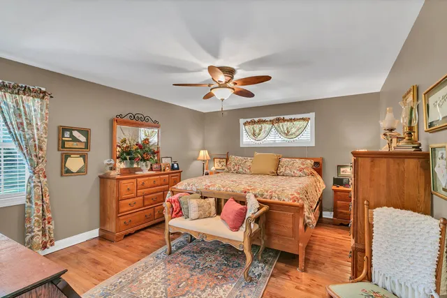 a spacious bedroom with a bed and a table in it