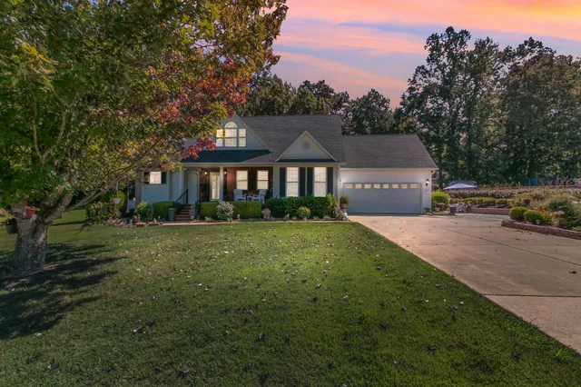a front view of a house with a garden