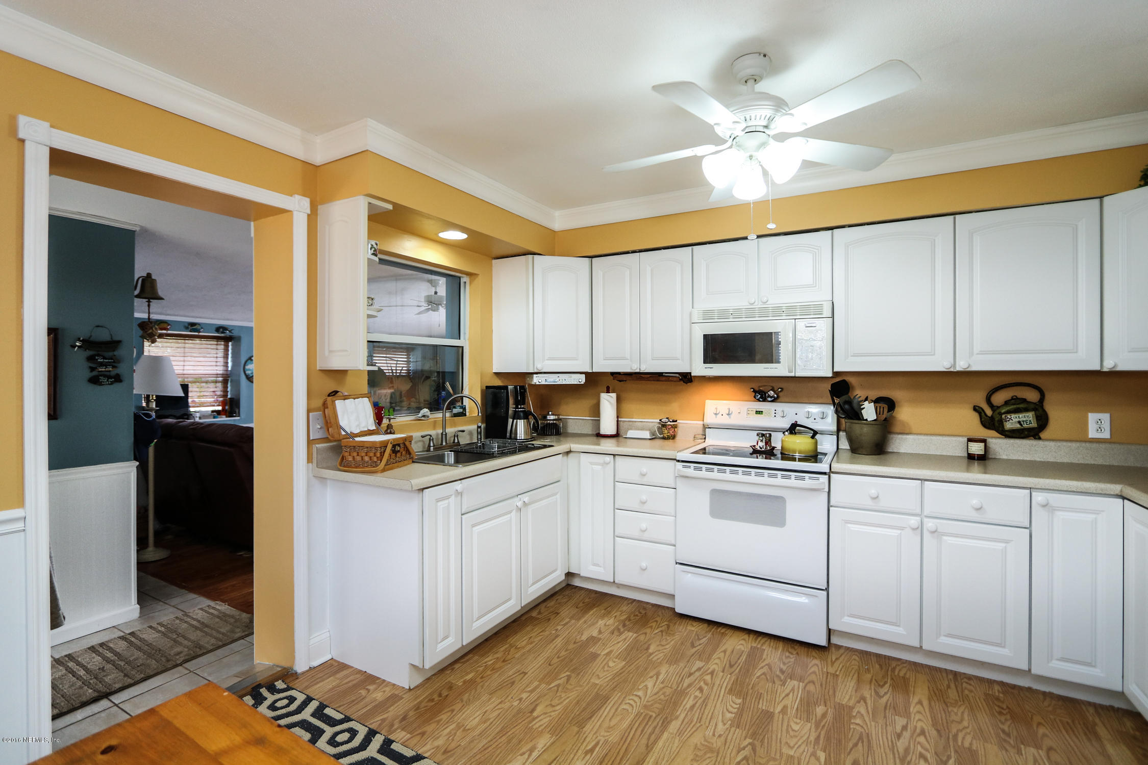 7648 Rambler Road Jacksonville, FL 32244 - Photo 11 of 29 a kitchen with white cabinets and sink