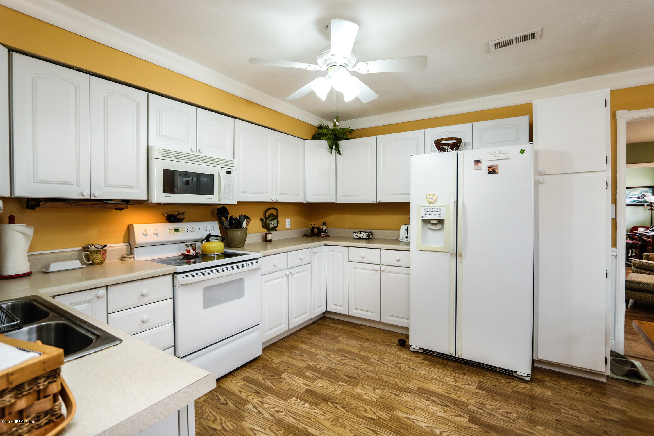 7648 Rambler Road Jacksonville, FL 32244 - Photo 12 of 29 a kitchen with stainless steel appliances granite countertop a refrigerator sink and cabinets