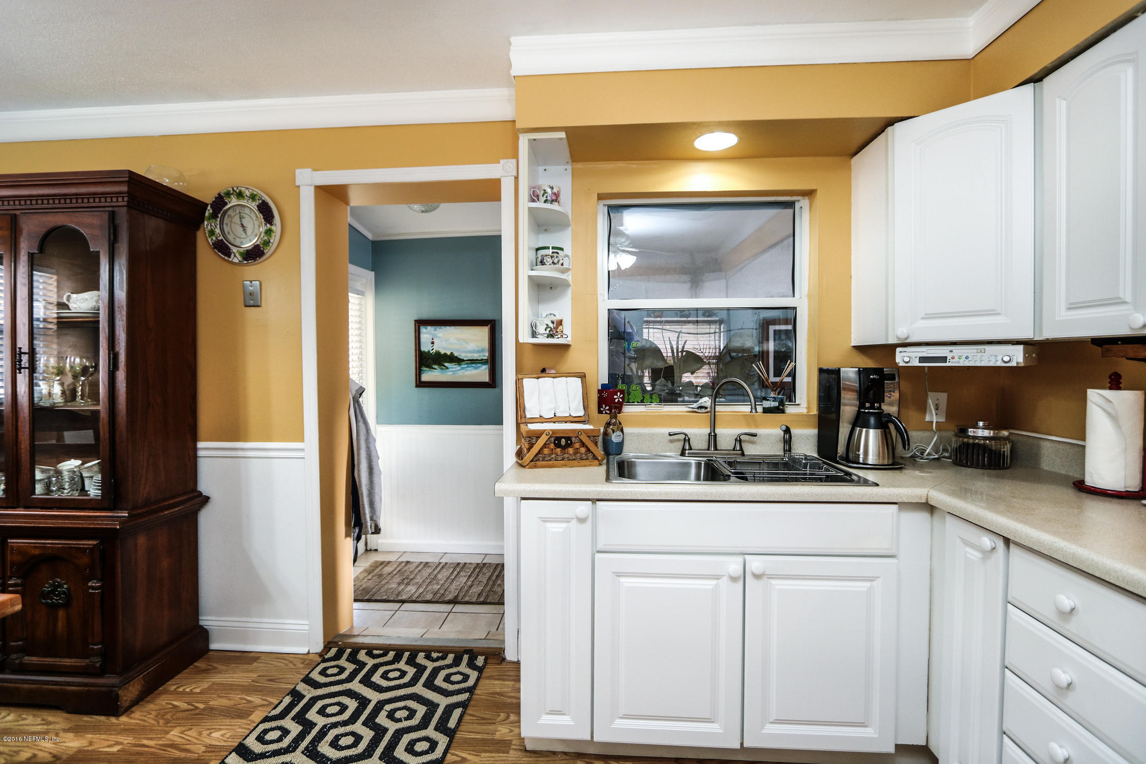 7648 Rambler Road Jacksonville, FL 32244 - Photo 13 of 29 a kitchen with white cabinets and sink