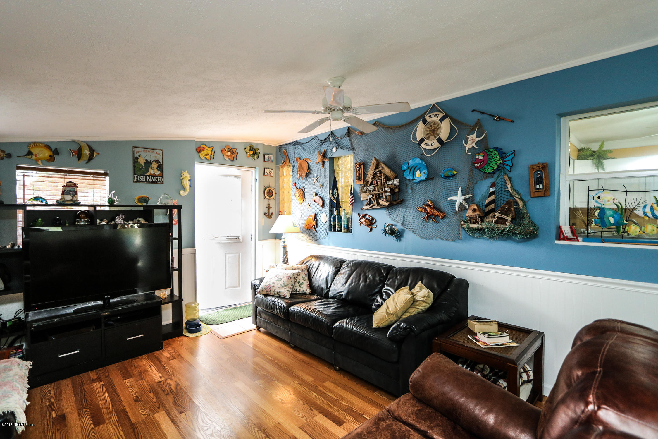 7648 Rambler Road Jacksonville, FL 32244 - Photo 15 of 29 a living room with furniture and a flat screen tv