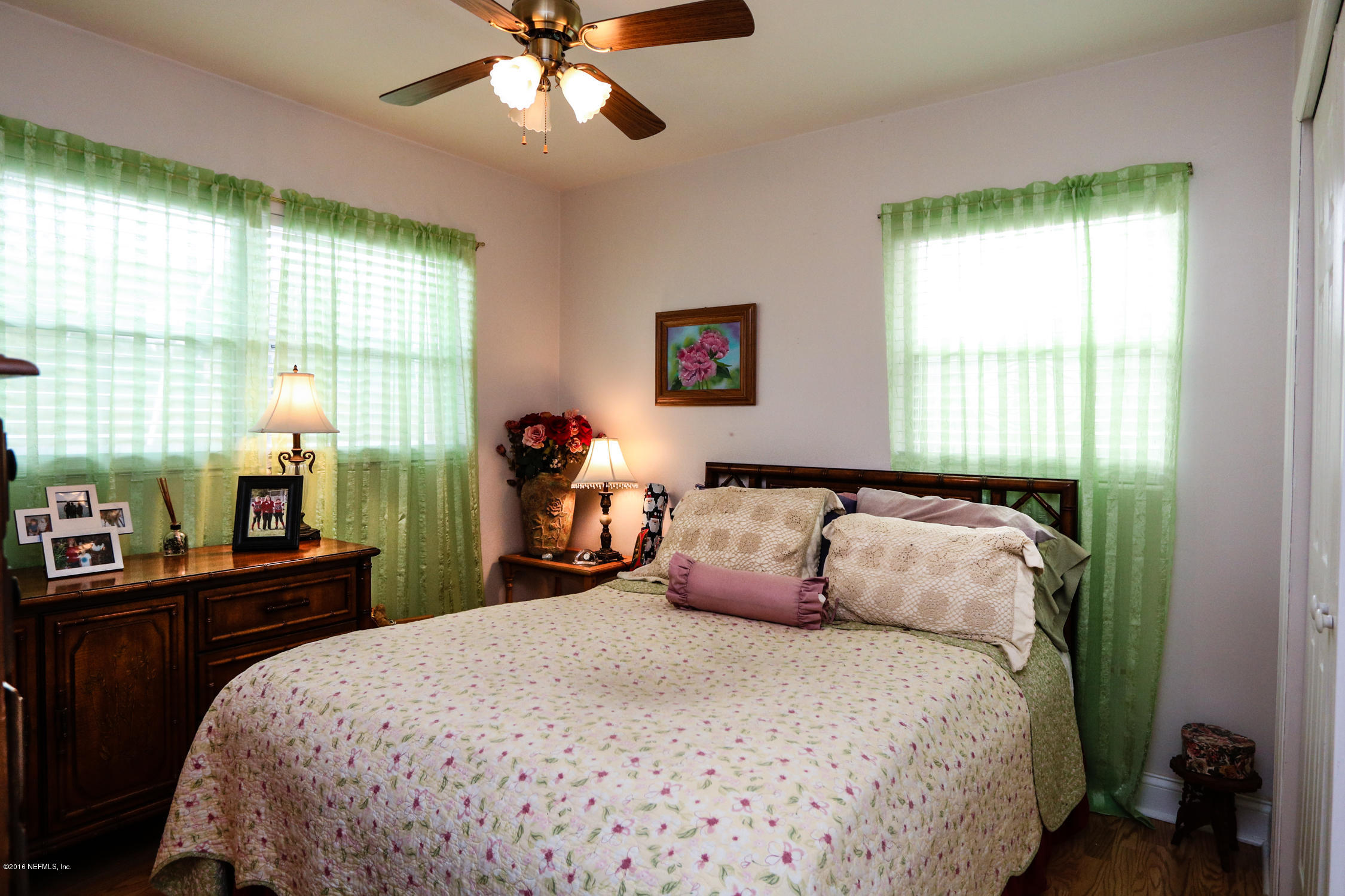 7648 Rambler Road Jacksonville, FL 32244 - Photo 17 of 29 a bedroom with a bed and a large window