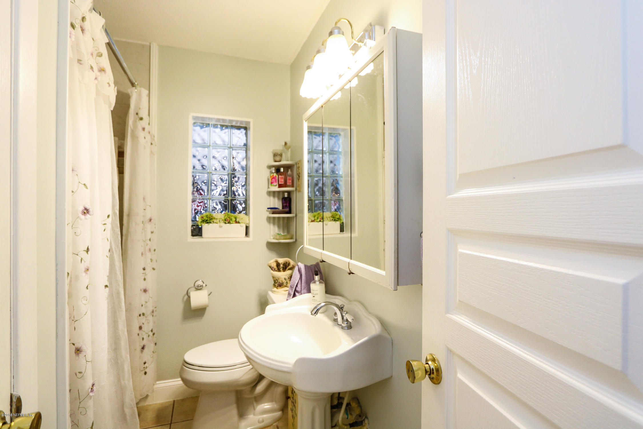 7648 Rambler Road Jacksonville, FL 32244 - Photo 21 of 29 a bathroom with a sink toilet and shower