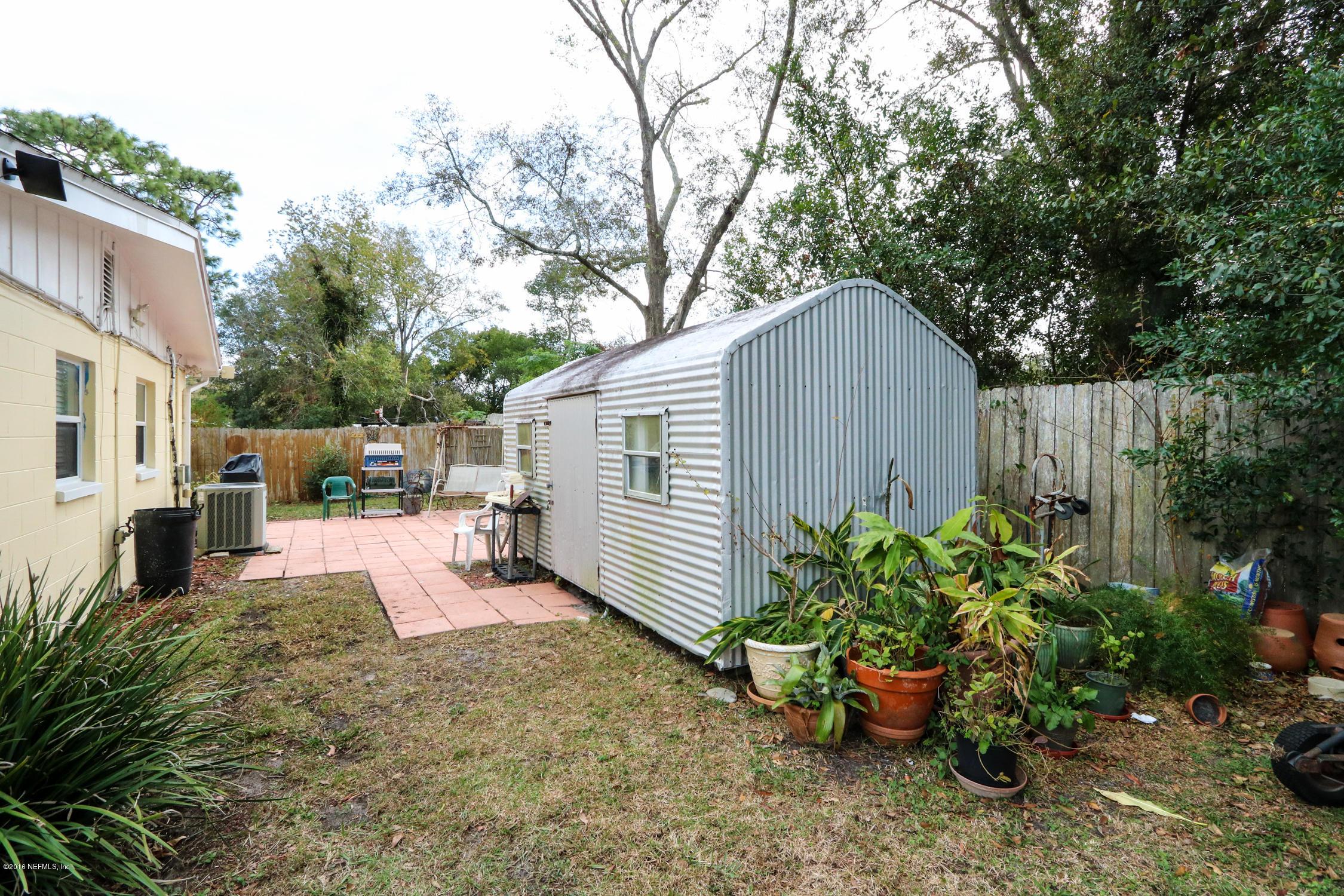 7648 Rambler Road Jacksonville, FL 32244 - Photo 25 of 29 a view of a backyard with sitting area and garden
