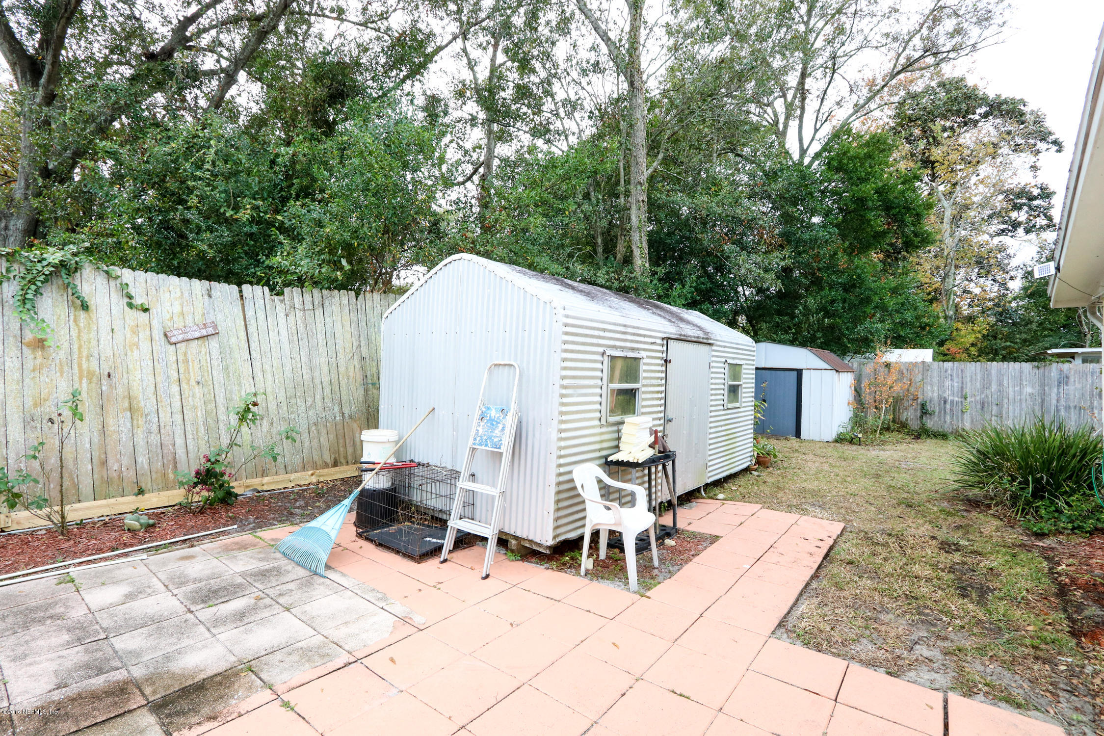7648 Rambler Road Jacksonville, FL 32244 - Photo 26 of 29 a view of backyard with outdoor seating and trees