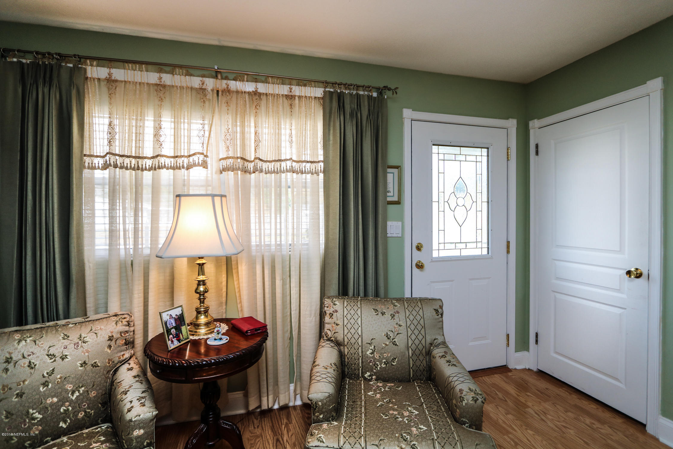 7648 Rambler Road Jacksonville, FL 32244 - Photo 4 of 29 a living room with furniture and a window