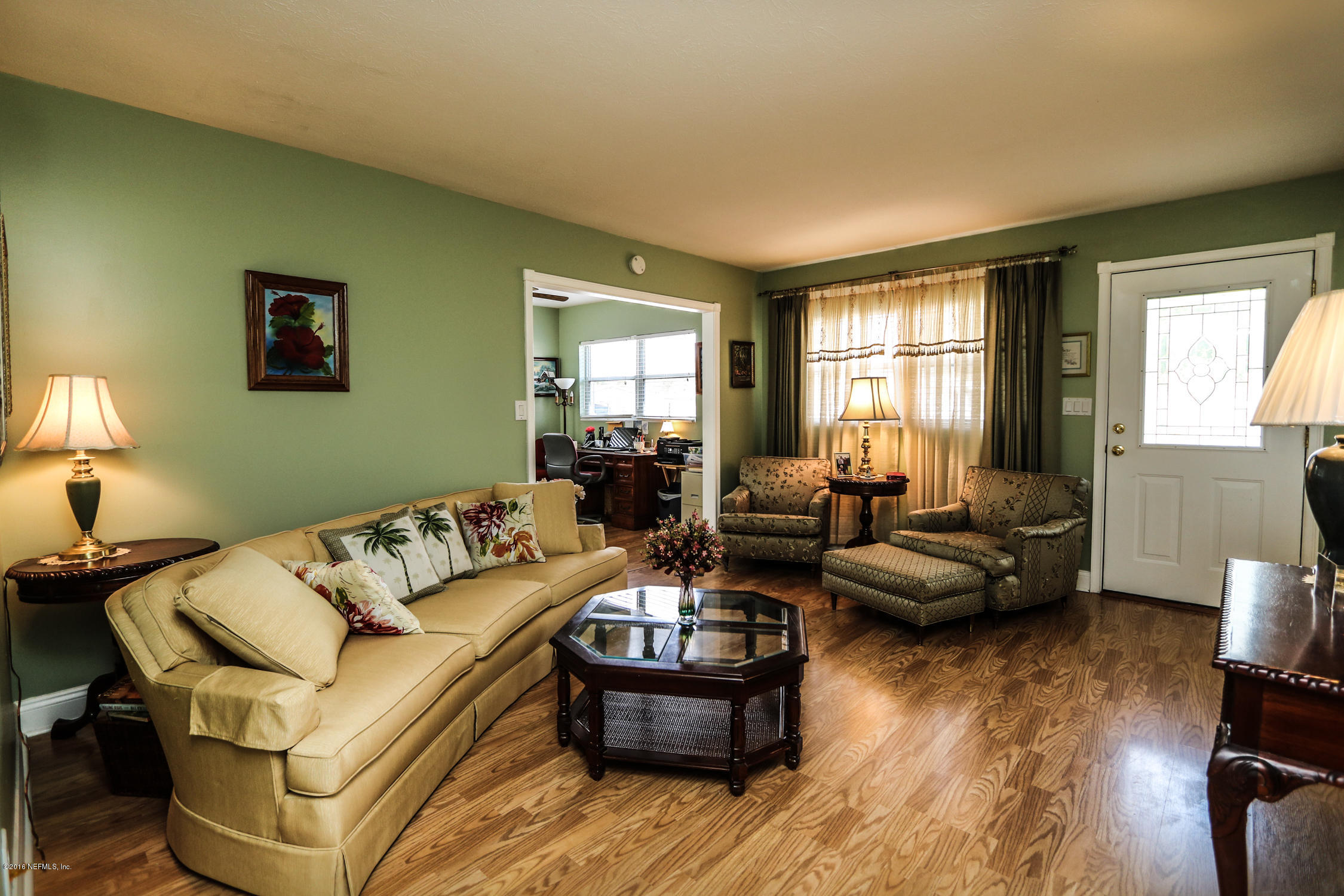 7648 Rambler Road Jacksonville, FL 32244 - Photo 7 of 29 a living room with furniture and a large window