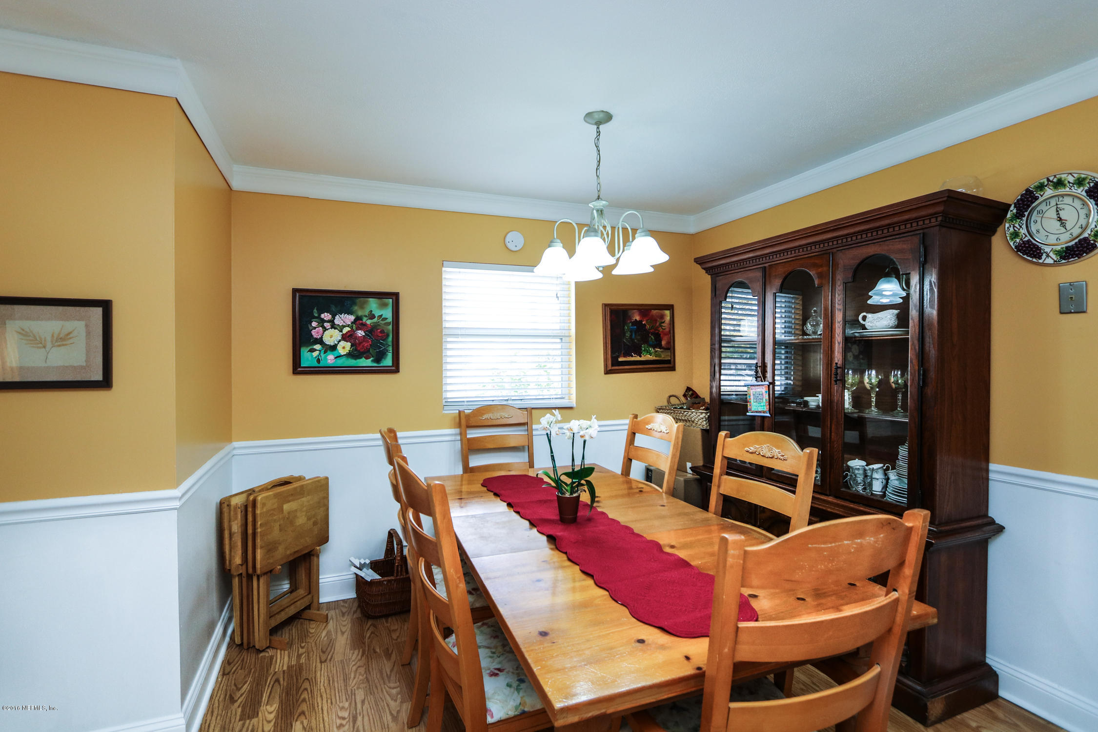 7648 Rambler Road Jacksonville, FL 32244 - Photo 9 of 29 a view of a dining room with furniture and a chandelier
