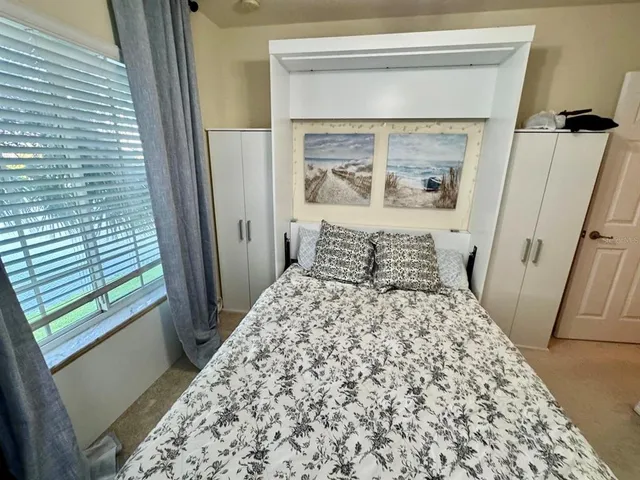 a large bed sitting in a bedroom next to a small yard