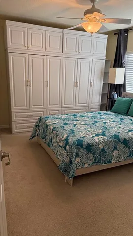 a bed sitting in a bedroom next to a cabinet