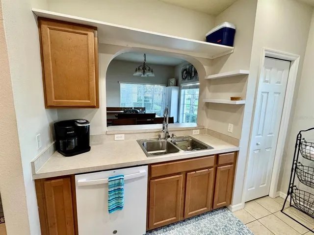 a kitchen with stainless steel appliances granite countertop a sink and a refrigerator
