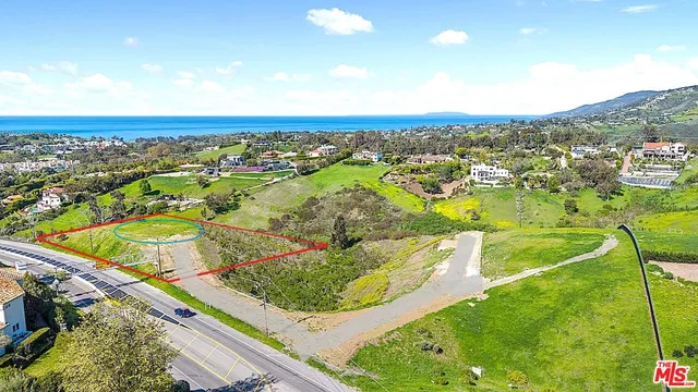 an aerial view of residential houses with outdoor space and swimming pool