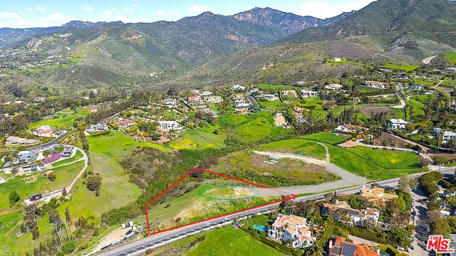 an aerial view of residential houses with outdoor space and swimming pool